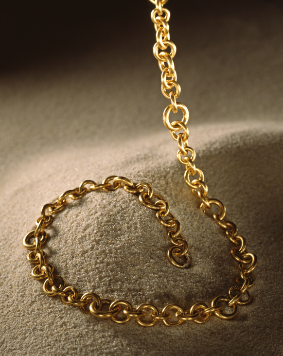 Goldkette auf Sand