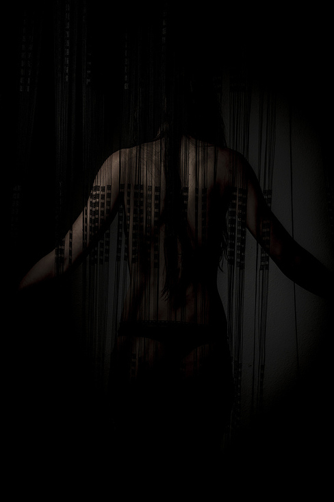 Night, nude woman back through a curtain