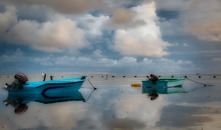 Fishing Boat at the mirror Sea