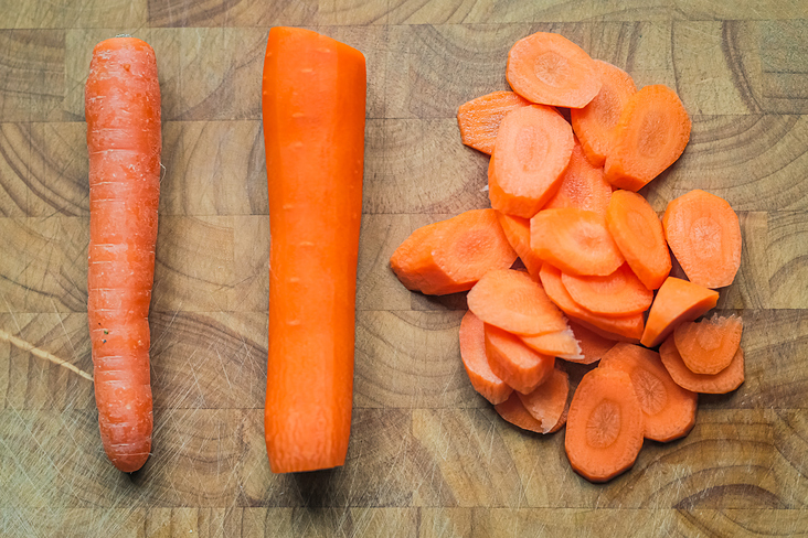 Different stages of a carrot. Unpeeled. peeled and cut. Trinity.
