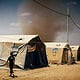 arising sandstorm in a refugee camp