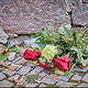 Bouquet of flowers fallen over by the wind next to the entrance door of the synagogue.